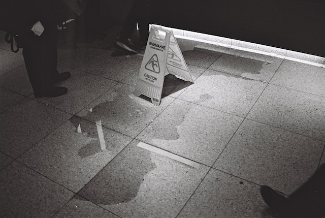 wet floor sign near puddle