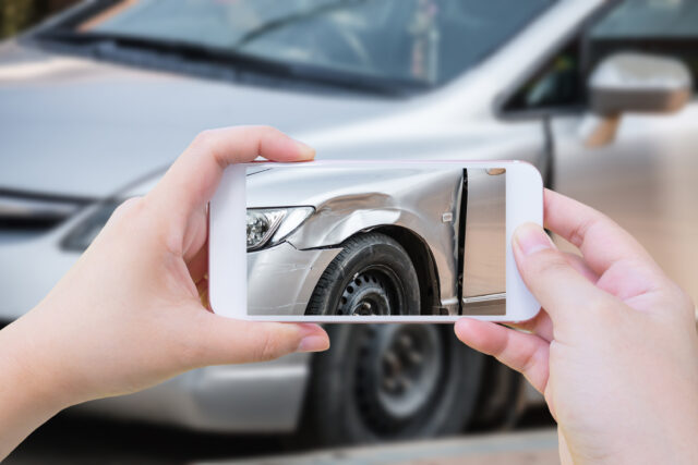 woman using mobile smartphone take photo car crash accident of the damage to the car for accident insurance